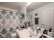 Bathroom with a white vanity and decorative shower curtain at 12439 W Monte Vista Rd, Avondale, AZ 85392