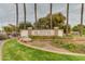 Well-manicured Rancho Santa Fe community entrance featuring lush landscaping at 12439 W Monte Vista Rd, Avondale, AZ 85392