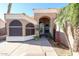 Inviting entryway with tiled walkway, desert landscaping, palm trees and an arched entry at 12439 W Monte Vista Rd, Avondale, AZ 85392