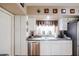 Well-lit kitchen with white cabinets, stainless steel appliances, and ample counter space for food preparation at 12439 W Monte Vista Rd, Avondale, AZ 85392