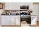 Functional kitchen layout with modern appliances, white cabinetry, and plenty of counter space for cooking at 12439 W Monte Vista Rd, Avondale, AZ 85392