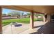 Relaxing covered patio area with a charming fire pit and a serene view of the lush backyard at 12439 W Monte Vista Rd, Avondale, AZ 85392