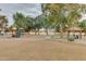 A well-maintained playground features playground equipment, park benches and shelters, and mature landscaping at 12439 W Monte Vista Rd, Avondale, AZ 85392