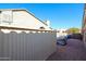 Side yard with gravel, partial fence, and partial view of neighboring houses at 12439 W Monte Vista Rd, Avondale, AZ 85392