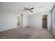 This bedroom offers neutral walls and carpet, and views into a walk-in closet and hallway at 13569 W Ventura St, Surprise, AZ 85379