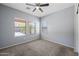 Bright bedroom with three windows providing ample natural light and plush carpeting at 13569 W Ventura St, Surprise, AZ 85379