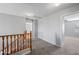 Hallway with neutral carpeting and wood banister at 13569 W Ventura St, Surprise, AZ 85379