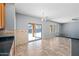 Eat in kitchen area featuring dark countertops, tile flooring, and view of backyard and pool at 13569 W Ventura St, Surprise, AZ 85379