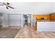 Open-concept living area with tile flooring connects seamlessly to the eat-in kitchen at 13569 W Ventura St, Surprise, AZ 85379