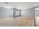 Bright living room with tile floors, a neutral wall color, and large windows providing ample natural light at 13569 W Ventura St, Surprise, AZ 85379