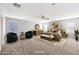 Stylishly staged main bedroom with a ceiling fan and plush carpeting at 13569 W Ventura St, Surprise, AZ 85379