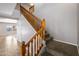 Staircase with wooden banister and neutral carpeting at 13569 W Ventura St, Surprise, AZ 85379