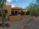 Inviting back patio with outdoor seating and well-maintained desert landscaping at 1489 Thrasher Ln, Wickenburg, AZ 85390