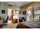 Bedroom with a sitting area, a desk, and plantation shutters at 1489 Thrasher Ln, Wickenburg, AZ 85390