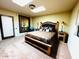 Bedroom with a large bed, high ceilings, and an elegant Southwestern painting at 1489 Thrasher Ln, Wickenburg, AZ 85390