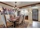 Dining room features a wooden table, elegant chairs, and an eye-catching light fixture at 1489 Thrasher Ln, Wickenburg, AZ 85390