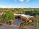 Expansive desert home featuring a multi-car garage, mature trees, and beautiful desert landscaping at 1489 Thrasher Ln, Wickenburg, AZ 85390