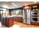 A kitchen featuring stainless steel appliances, wooden cabinets, and an island at 1489 Thrasher Ln, Wickenburg, AZ 85390