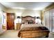 A bedroom with a large bed, wooden accents, and an exterior view at 1489 Thrasher Ln, Wickenburg, AZ 85390