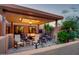 Relaxing covered patio area with plush seating and inviting fire pit at 1489 Thrasher Ln, Wickenburg, AZ 85390