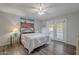 Bright bedroom showcases wood-look flooring, a ceiling fan, and french doors to the outside at 1601 E Elgin St, Chandler, AZ 85225