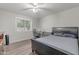 Bright bedroom with a ceiling fan, a desk, and wood-look floors at 1601 E Elgin St, Chandler, AZ 85225