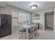 Bright dining room with a large window and a set of white chairs at 1601 E Elgin St, Chandler, AZ 85225