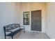 A cozy front porch with a welcome mat, a bench, and a security screen door at 1601 E Elgin St, Chandler, AZ 85225