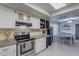 Well-lit kitchen with stainless steel appliances, granite countertops and a wine rack at 1601 E Elgin St, Chandler, AZ 85225