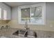 Bright kitchen sink area featuring granite countertops and a window with a view to the backyard at 1601 E Elgin St, Chandler, AZ 85225