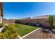 Lush backyard featuring a well-manicured lawn, mature landscaping, and a privacy fence, perfect for outdoor activities at 16561 W Cielo Grande Ave, Surprise, AZ 85387