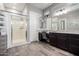 Bathroom featuring a glass shower, granite countertops, and wood-style flooring at 16561 W Cielo Grande Ave, Surprise, AZ 85387