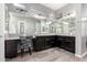 Bathroom featuring dual sinks, granite countertops, and wood-style flooring at 16561 W Cielo Grande Ave, Surprise, AZ 85387