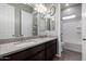 Bathroom with dual sinks, granite countertops, and a bathtub at 16561 W Cielo Grande Ave, Surprise, AZ 85387