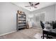 Bedroom with neutral tones, soft carpet, and a bookcase at 16561 W Cielo Grande Ave, Surprise, AZ 85387