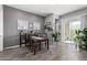 Dining room with seating for four, slider access to the outdoors, wood-look floors, and stylish decor at 16561 W Cielo Grande Ave, Surprise, AZ 85387