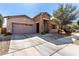 Eye-catching home exterior with stone entryway, desert landscaping, and a two-car garage, perfect for families at 16561 W Cielo Grande Ave, Surprise, AZ 85387