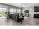 Modern living room with gray walls, wood-look floors, a sliding glass door, and a comfortable gray sofa at 16561 W Cielo Grande Ave, Surprise, AZ 85387