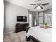 Serene bedroom with a neutral color palette, dark wood furniture, and a sliding barn door at 16561 W Cielo Grande Ave, Surprise, AZ 85387