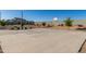 Outdoor basketball court with a hoop, surrounded by landscaping and a concrete block wall at 16846 W Molly Ln, Surprise, AZ 85387