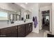 Bathroom features dual sinks, a large mirror, and a tiled floor at 16846 W Molly Ln, Surprise, AZ 85387