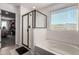 Bathroom with a soaking tub, separate glass-enclosed shower, and walk-in closet at 16846 W Molly Ln, Surprise, AZ 85387