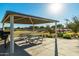 Covered common area with picnic tables, grill, and views of the green space at 16846 W Molly Ln, Surprise, AZ 85387