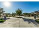 Open community space featuring shade structures, trees, and landscaping on a sunny day at 16846 W Molly Ln, Surprise, AZ 85387