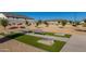 Community cornhole area with artificial turf, benches, and landscaping at 16846 W Molly Ln, Surprise, AZ 85387