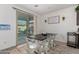 Bright dining room featuring a farmhouse table, seating for four, and sliding glass door at 16846 W Molly Ln, Surprise, AZ 85387