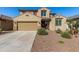 Charming two-story home with a well-maintained front yard and a two car garage at 16846 W Molly Ln, Surprise, AZ 85387