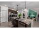 Modern kitchen featuring stainless steel appliances, granite countertops, and stylish pendant lighting at 16846 W Molly Ln, Surprise, AZ 85387