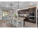 Modern kitchen featuring stainless steel appliances, granite countertops, a dining area and more at 16846 W Molly Ln, Surprise, AZ 85387