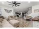 Bright living room featuring tile floors, neutral colored furniture and decor at 16846 W Molly Ln, Surprise, AZ 85387